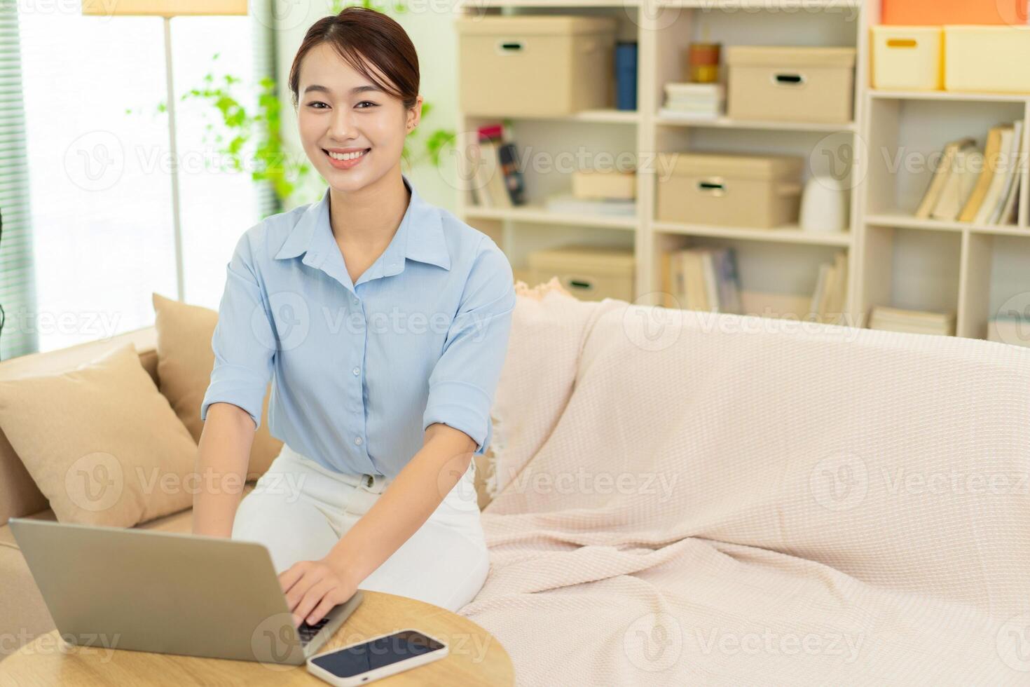 Photo of young Asian woman at home