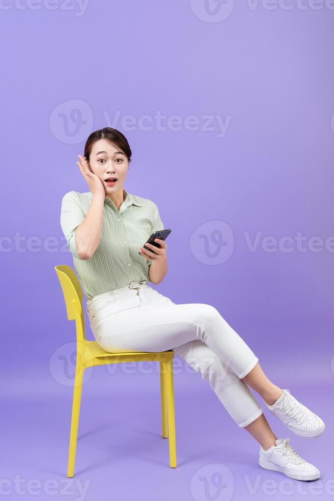 Photo of young Asian woman on purple background