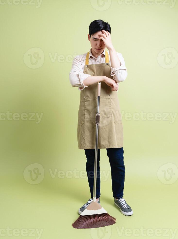 Photo of young Asian man on green background