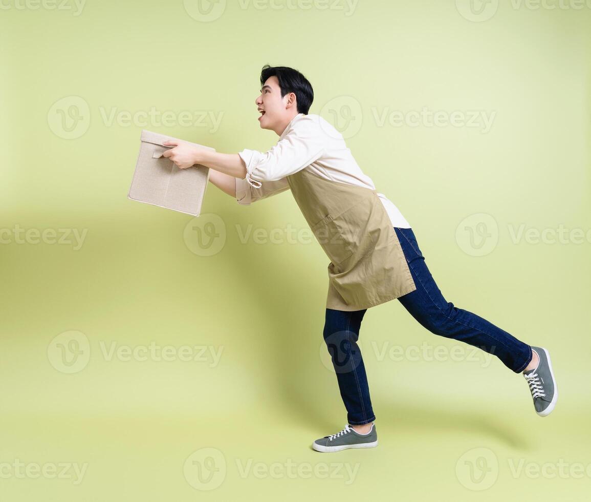 Photo of young Asian man on green background