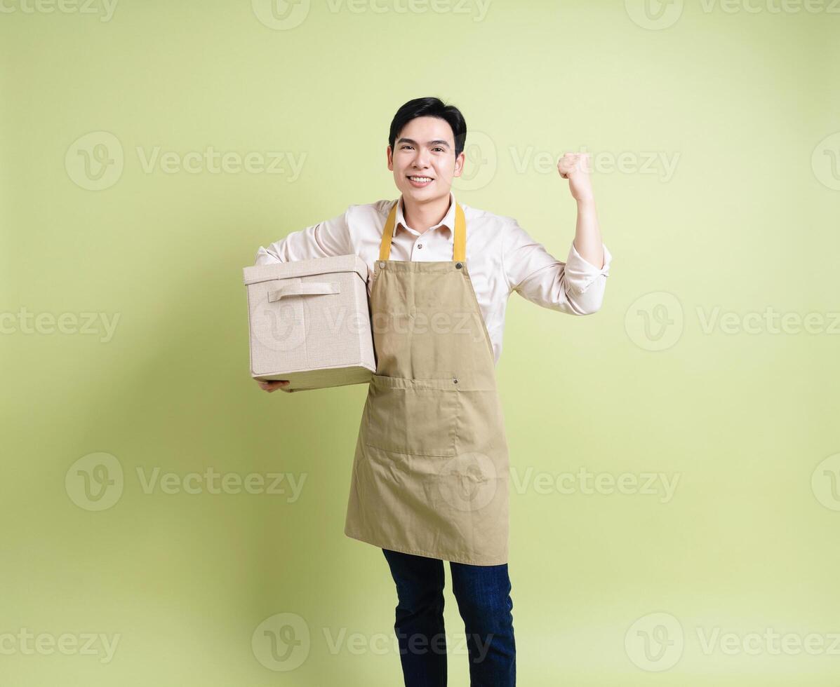 Photo of young Asian man on green background