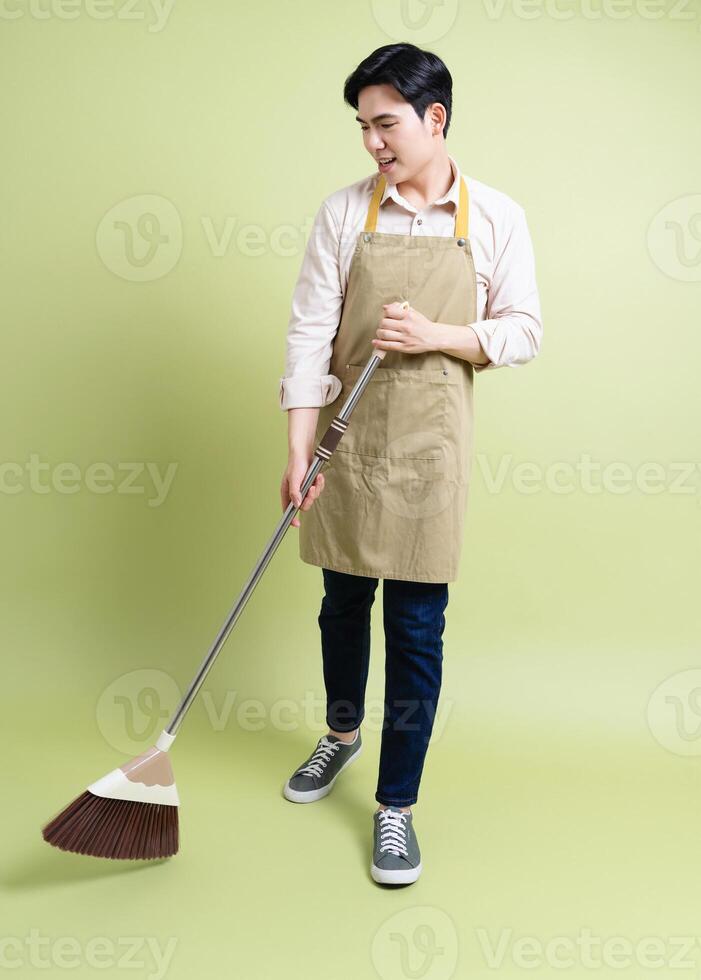 Photo of young Asian man on green background