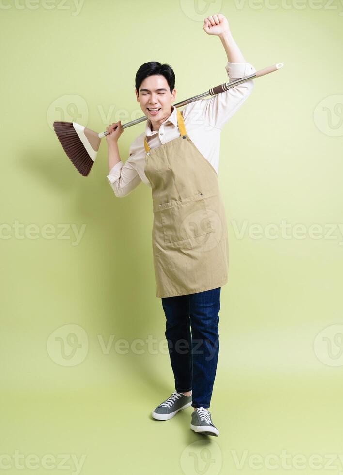 Photo of young Asian man on green background