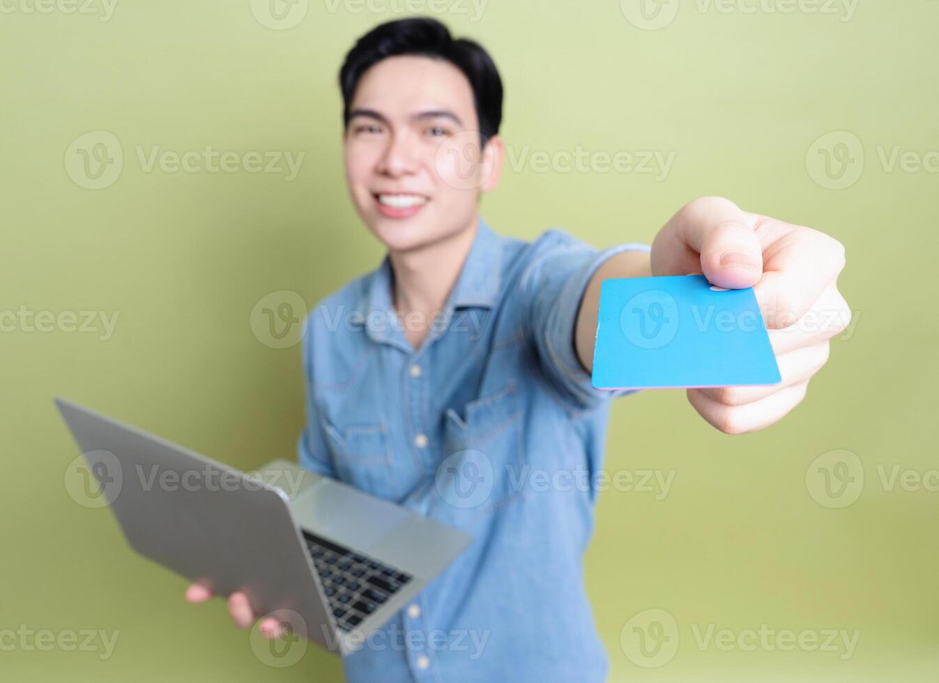 Photo of young Asian man on green background