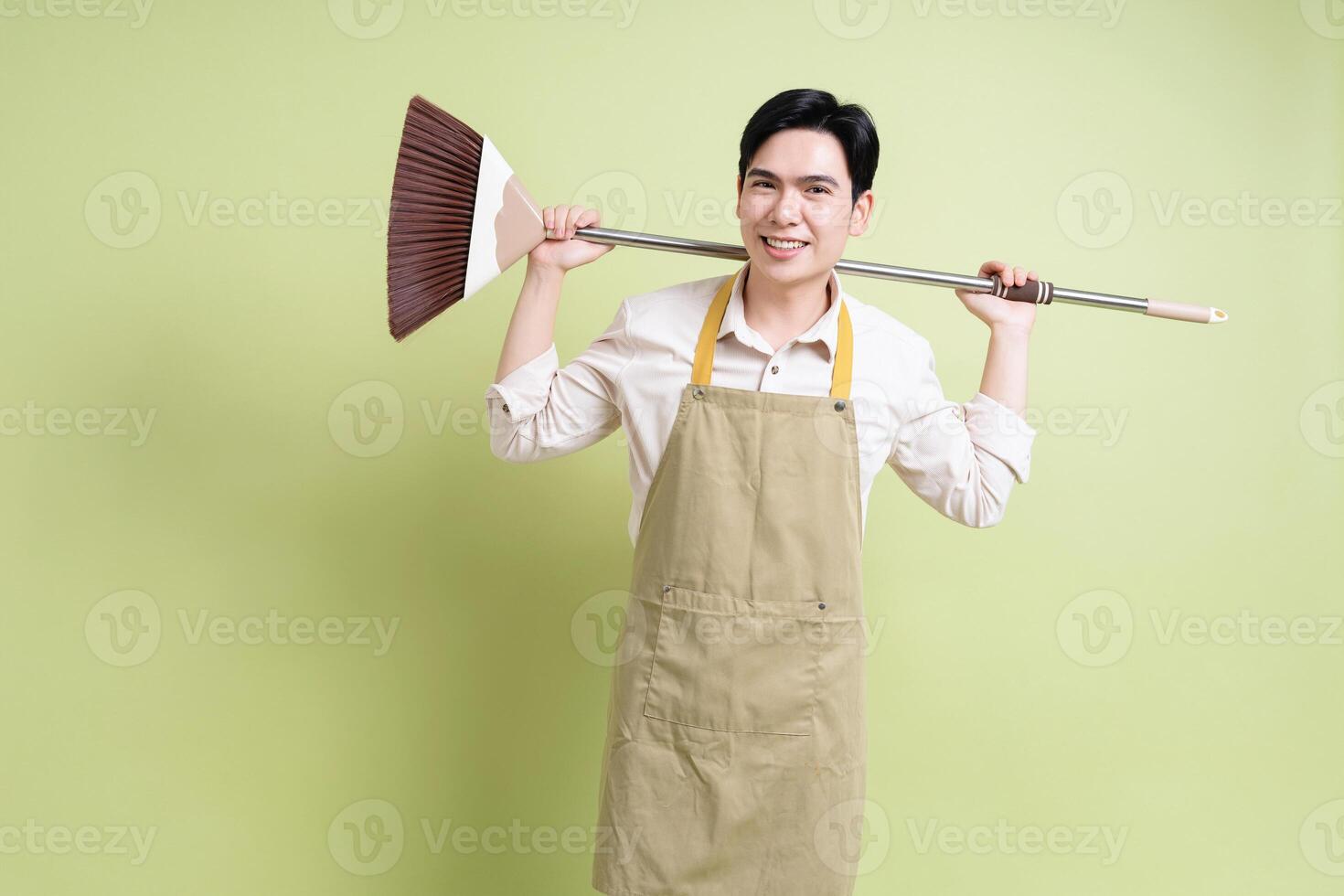 Photo of young Asian man on green background