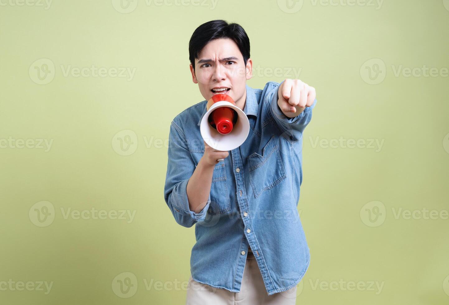 Photo of young Asian man on green background