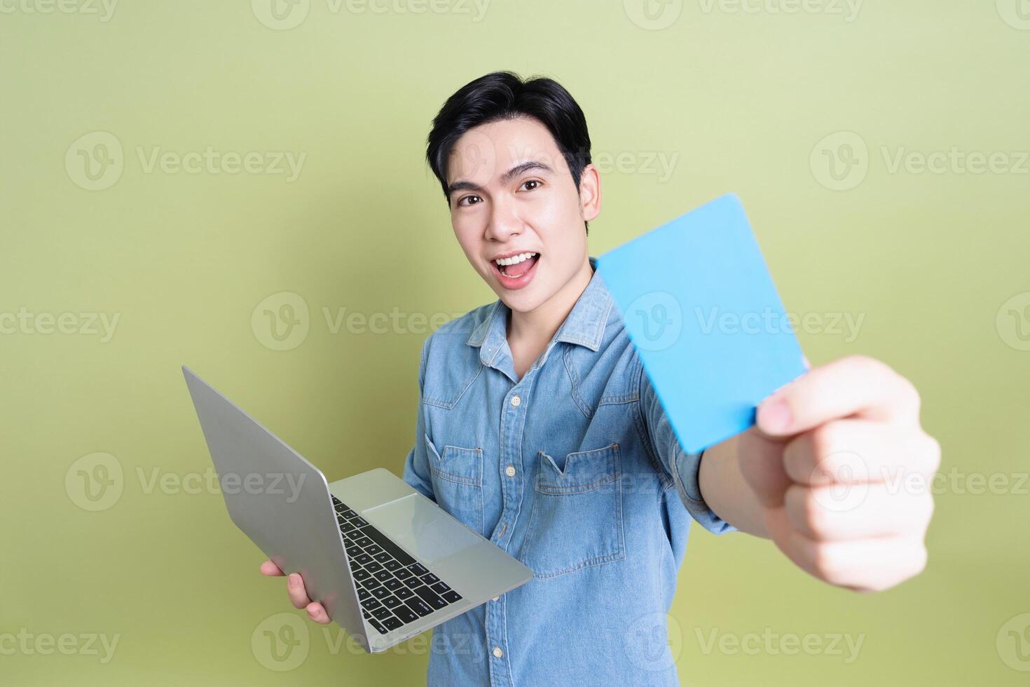 Photo of young Asian man on green background