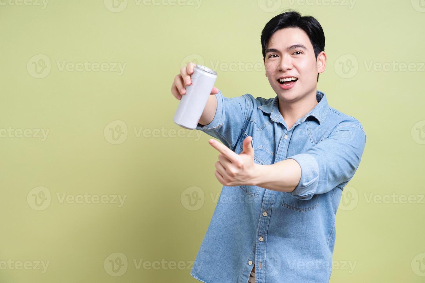 Photo of young Asian man on green background