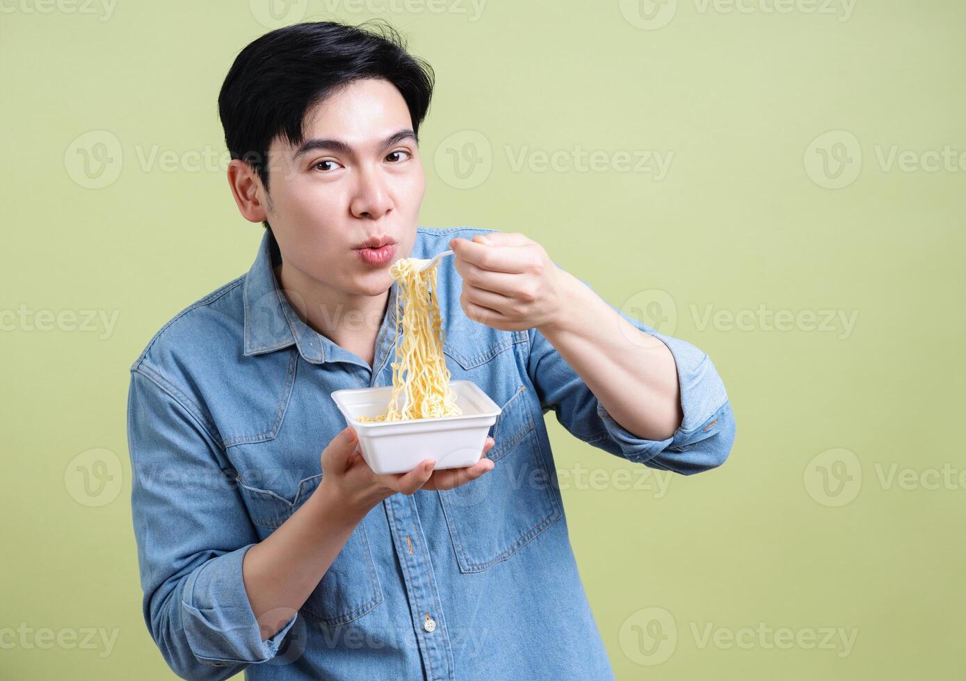 Photo of young Asian man on green background