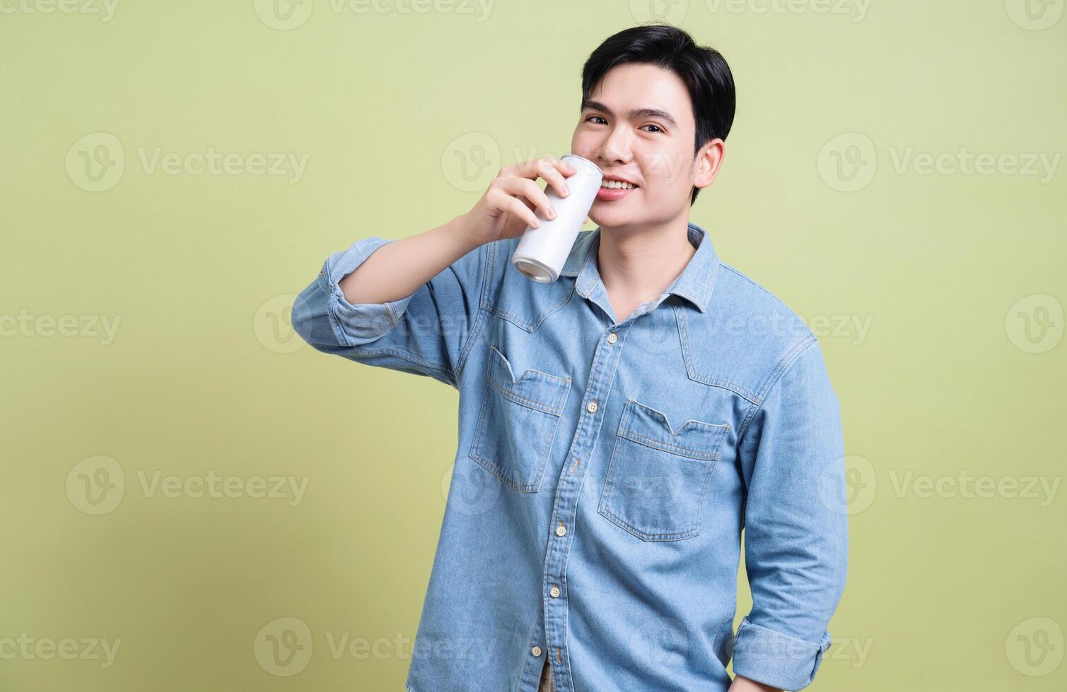 Photo of young Asian man on green background