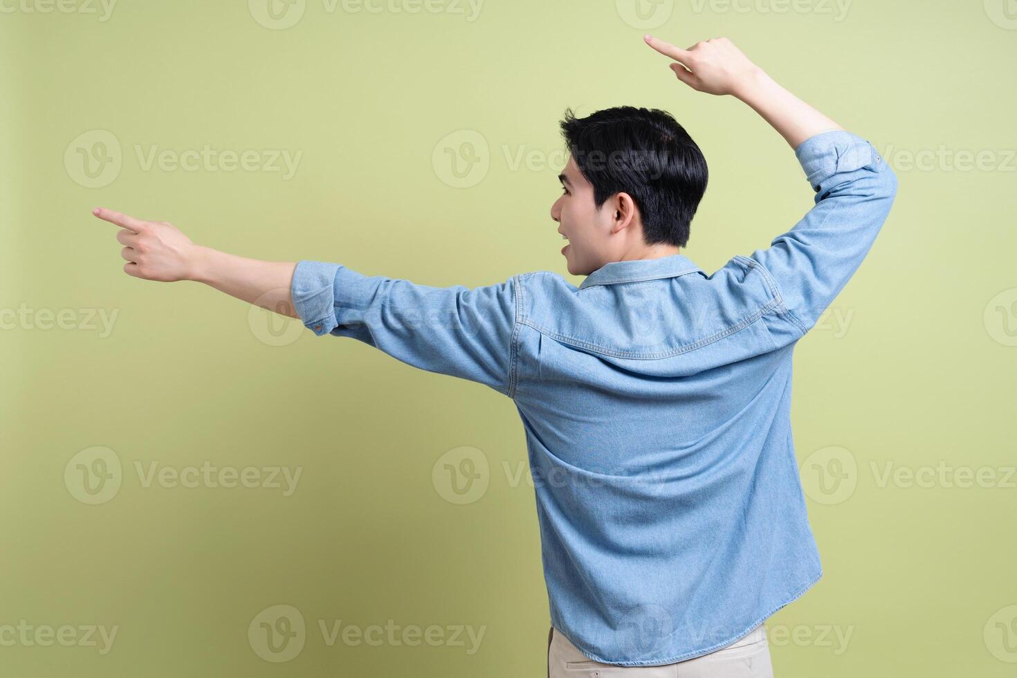 Photo of young Asian man on green background