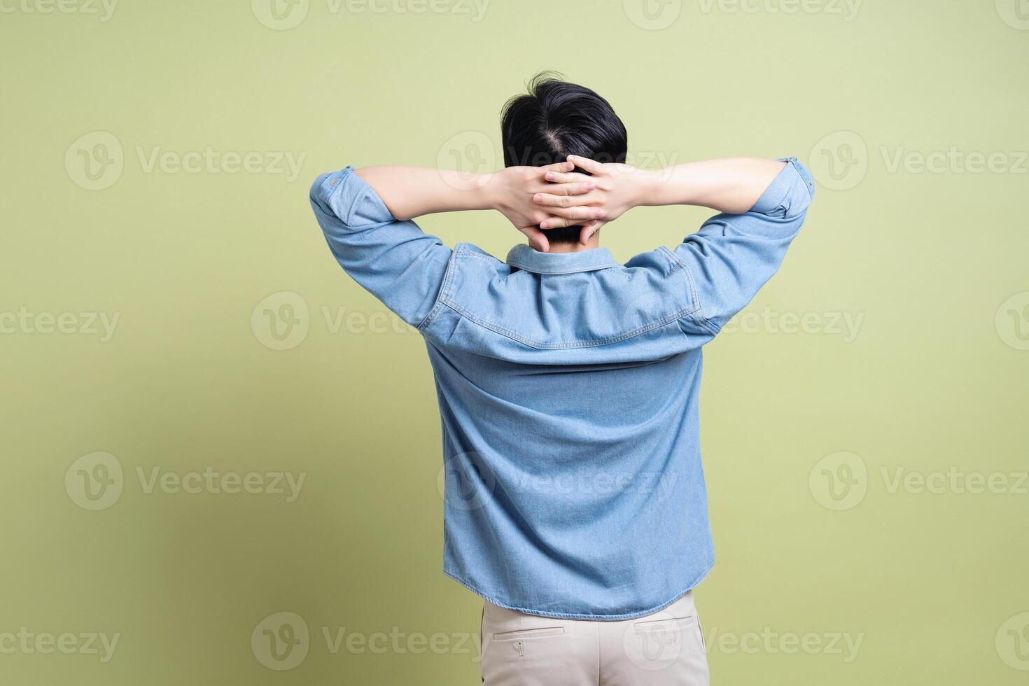 Photo of young Asian man on green background