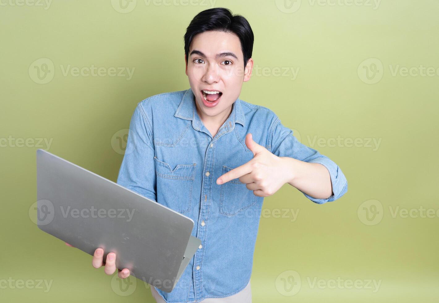 Photo of young Asian man on green background