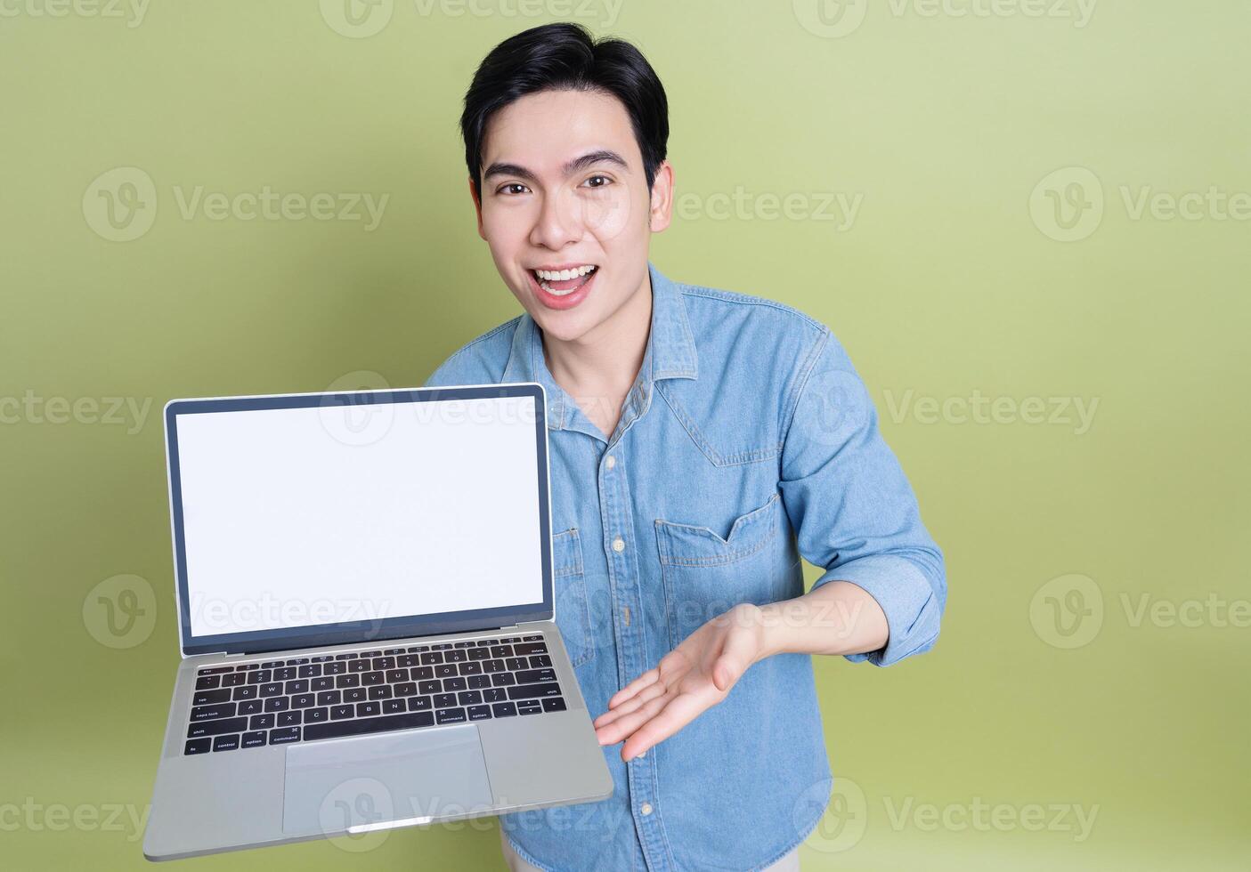 Photo of young Asian man on green background