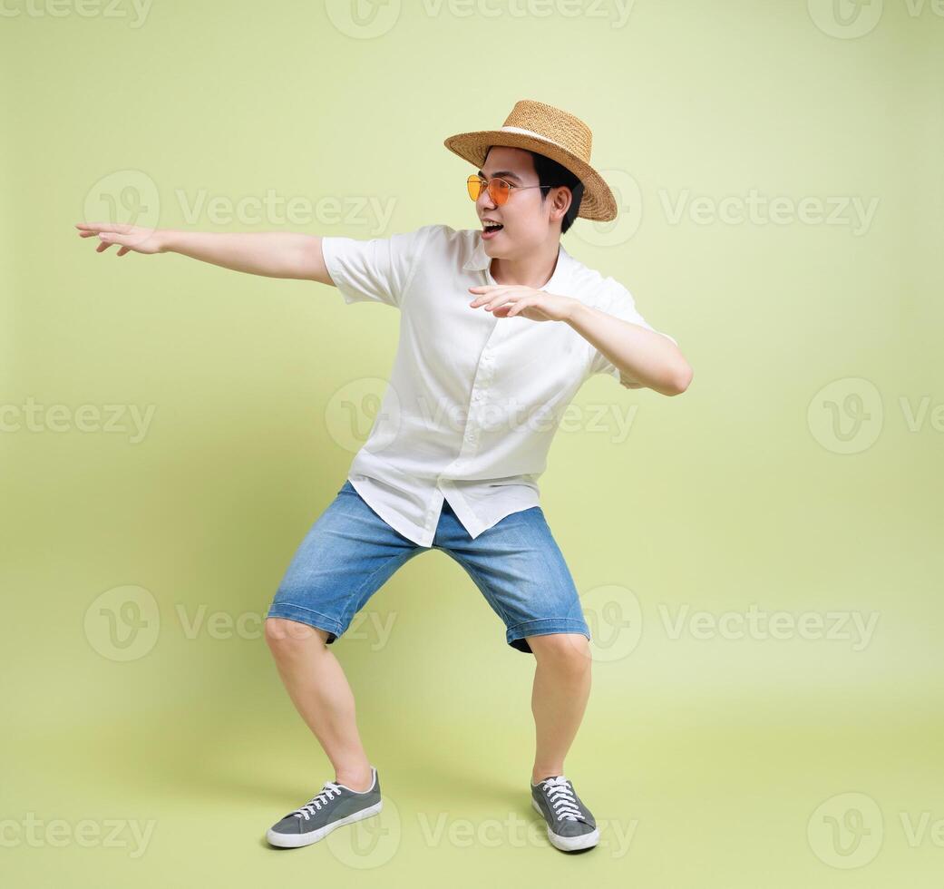 Photo of young Asian man on green background