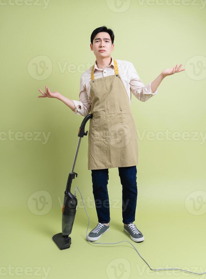 Photo of young Asian man on green background