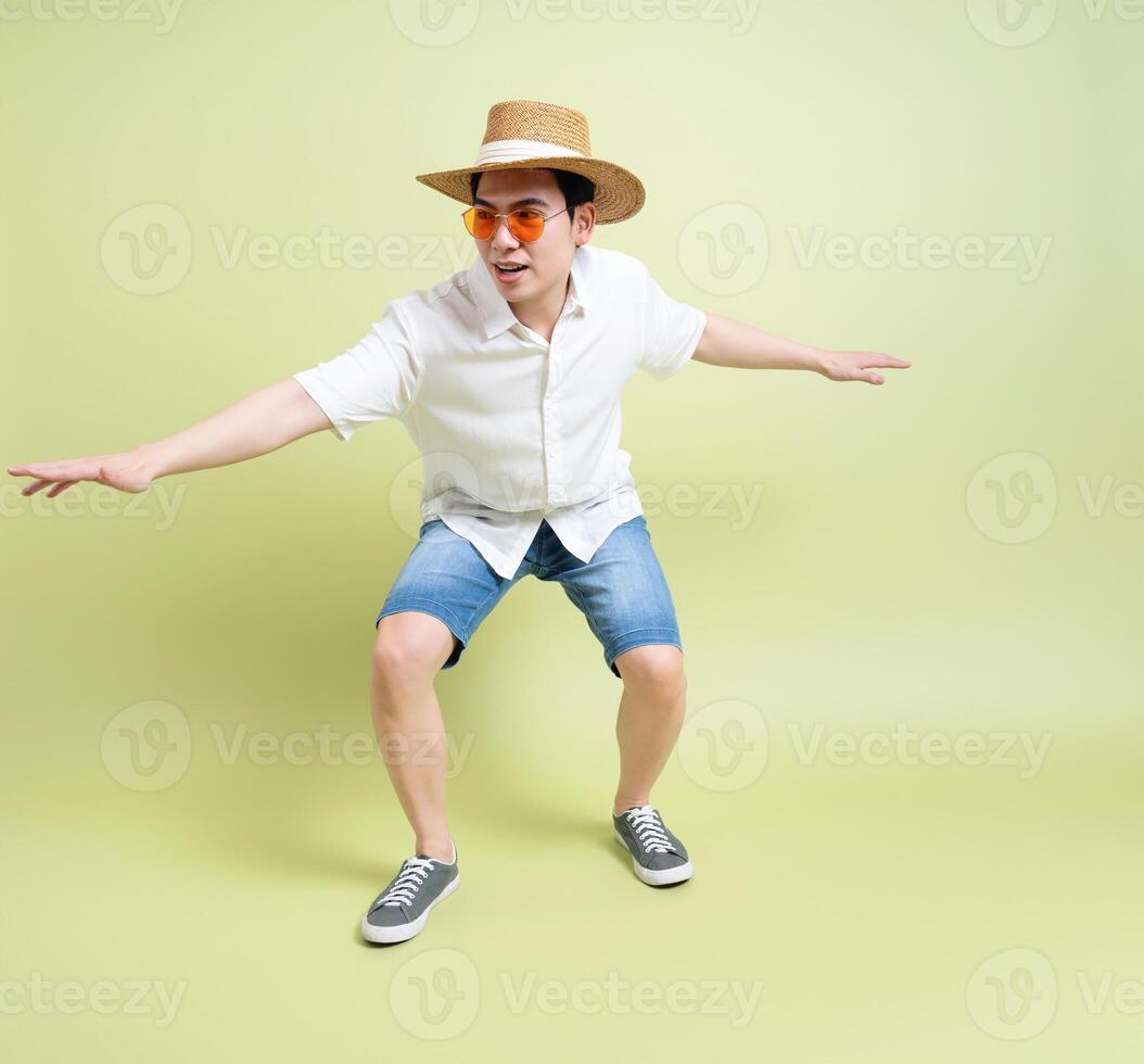 Photo of young Asian man on green background