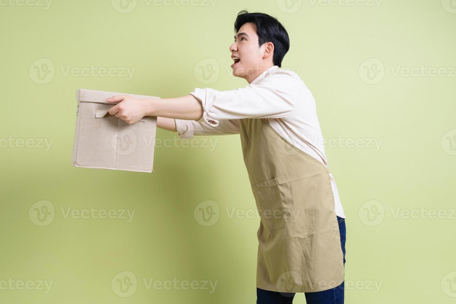 Photo of young Asian man on green background
