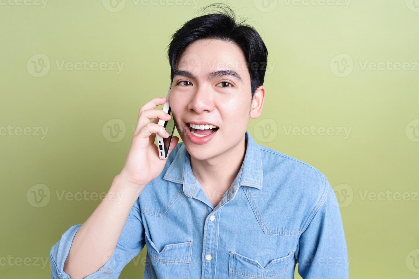 Photo of young Asian man on green background