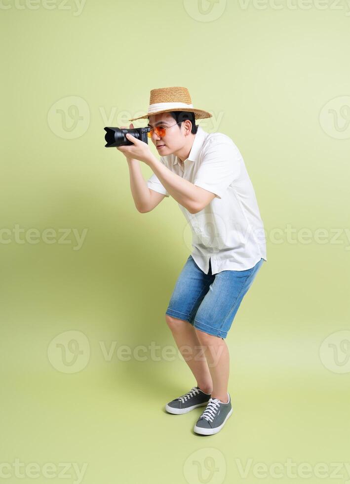 Photo of young Asian man on green background