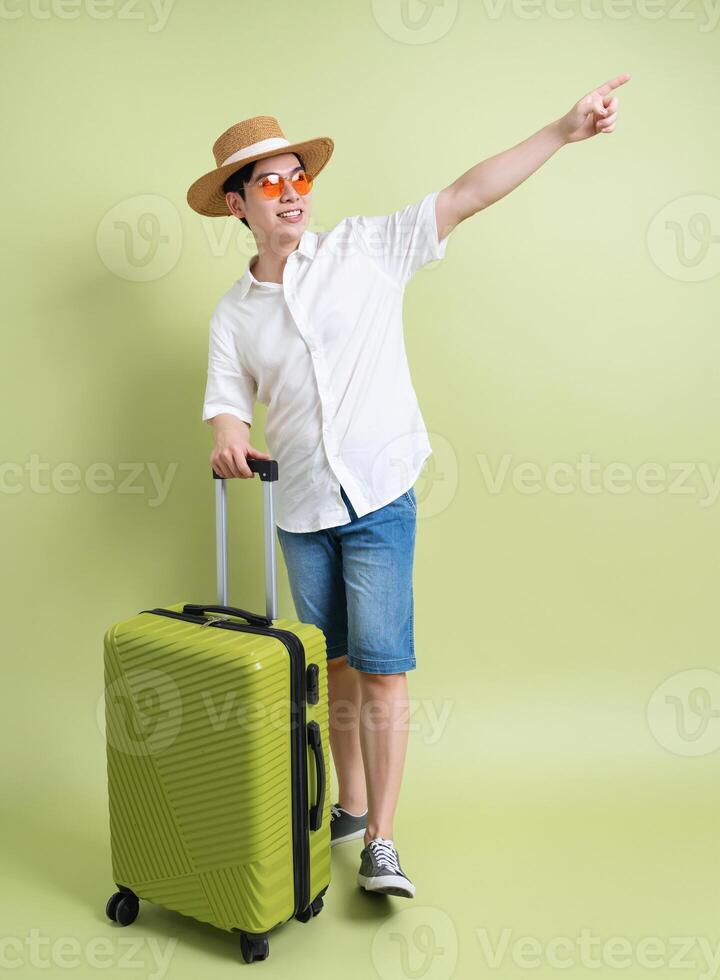 Photo of young Asian man on green background