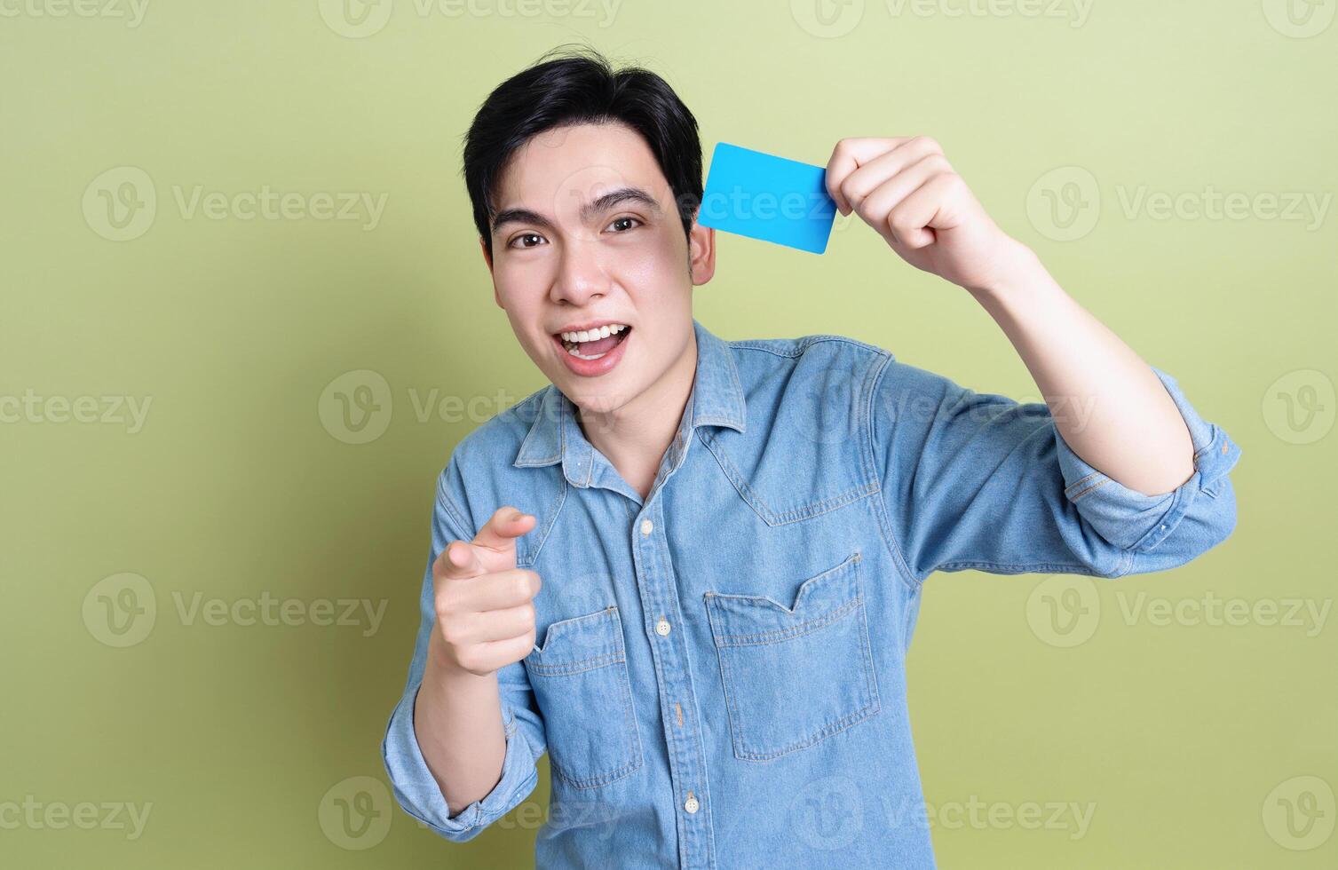 Photo of young Asian man on green background