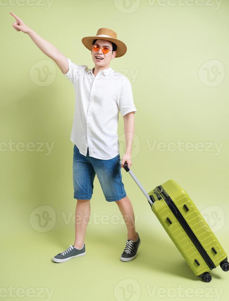 Photo of young Asian man on green background