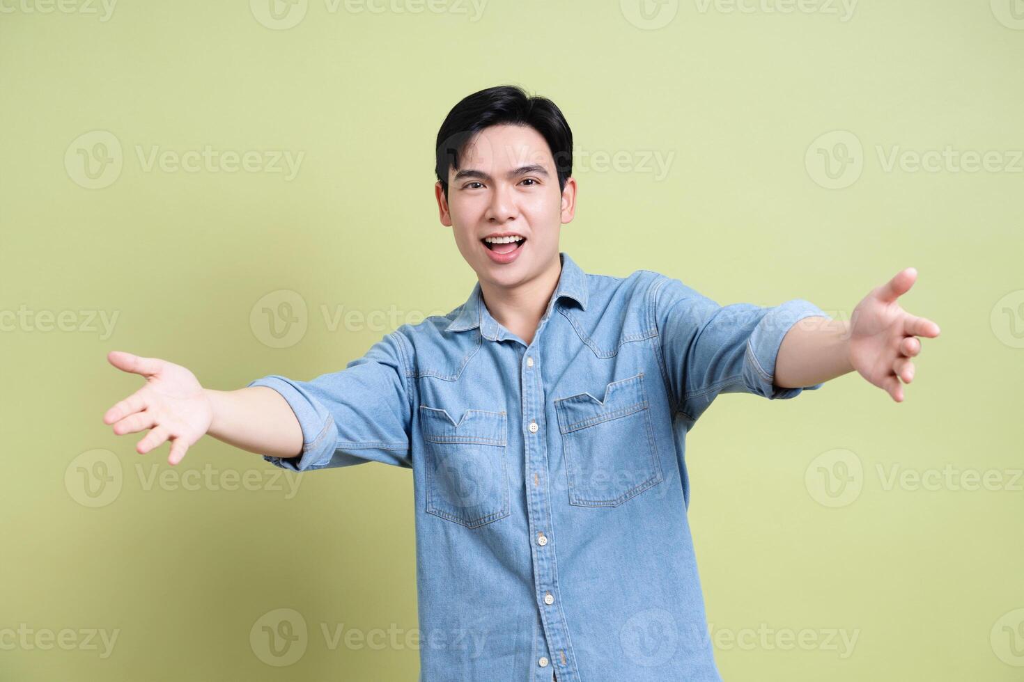 Photo of young Asian man on green background