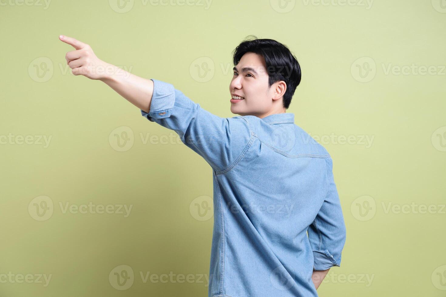 Photo of young Asian man on green background