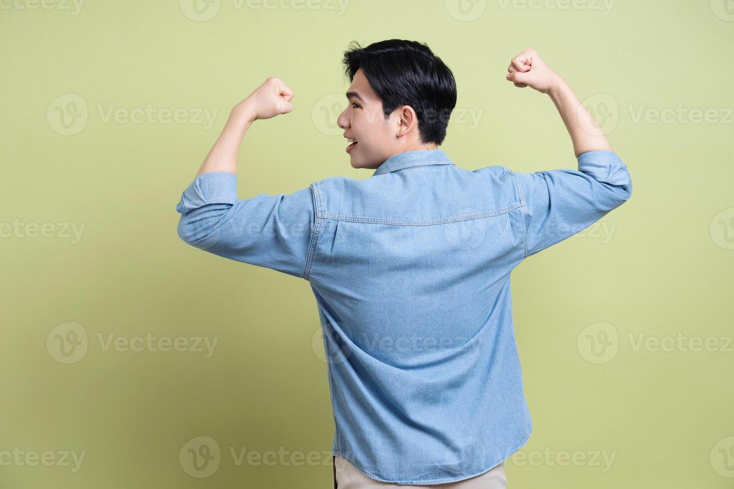 Photo of young Asian man on green background