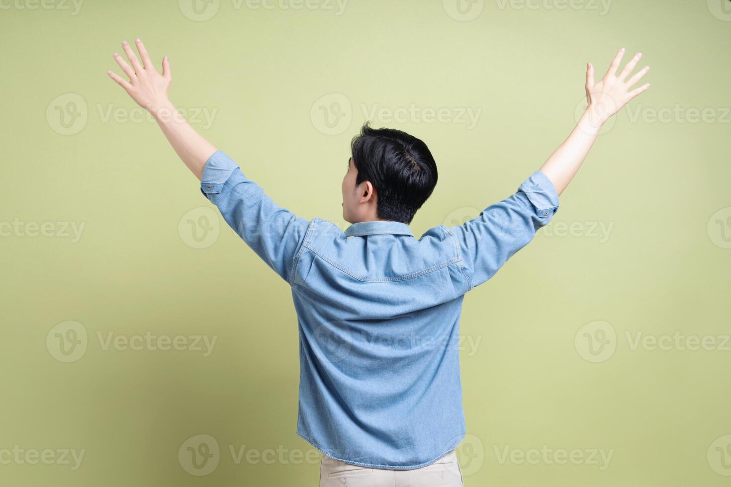 Photo of young Asian man on green background