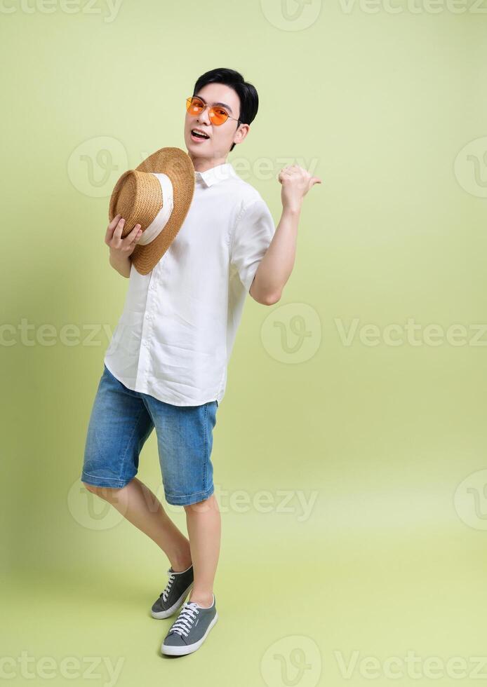 Photo of young Asian man on green background