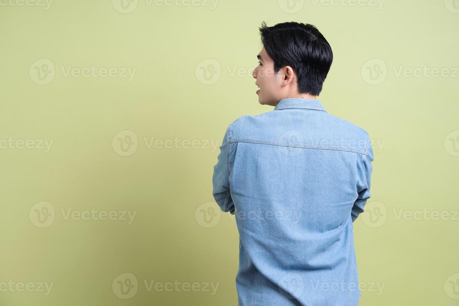 Photo of young Asian man on green background