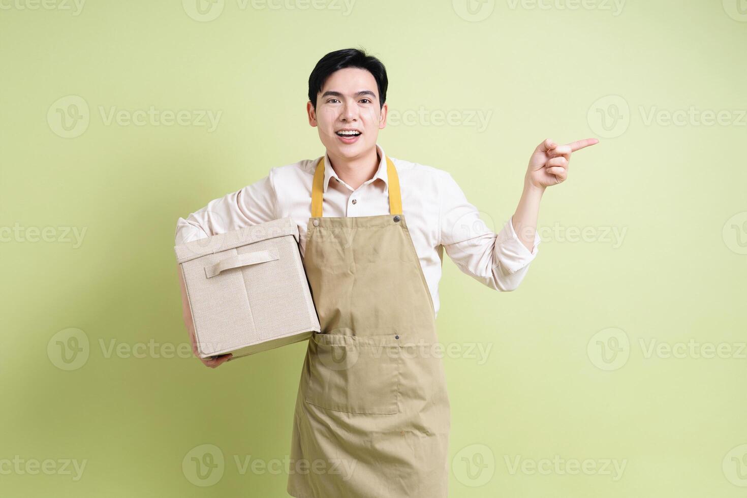 Photo of young Asian man on green background