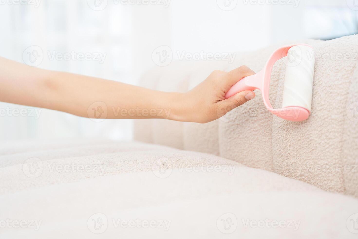 Young Asian woman cleaning sofa photo