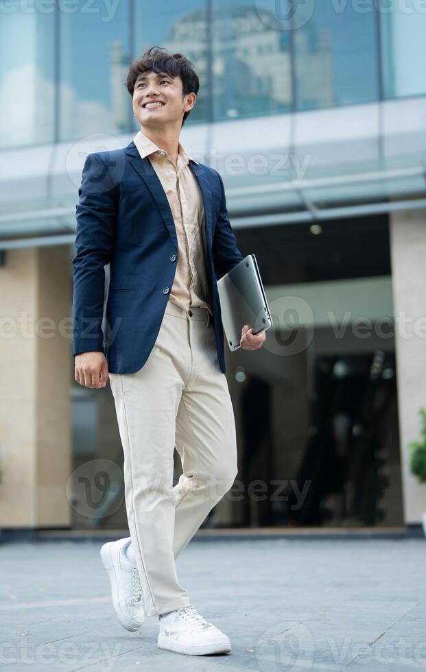 Portrait of young Asian businessman outside photo