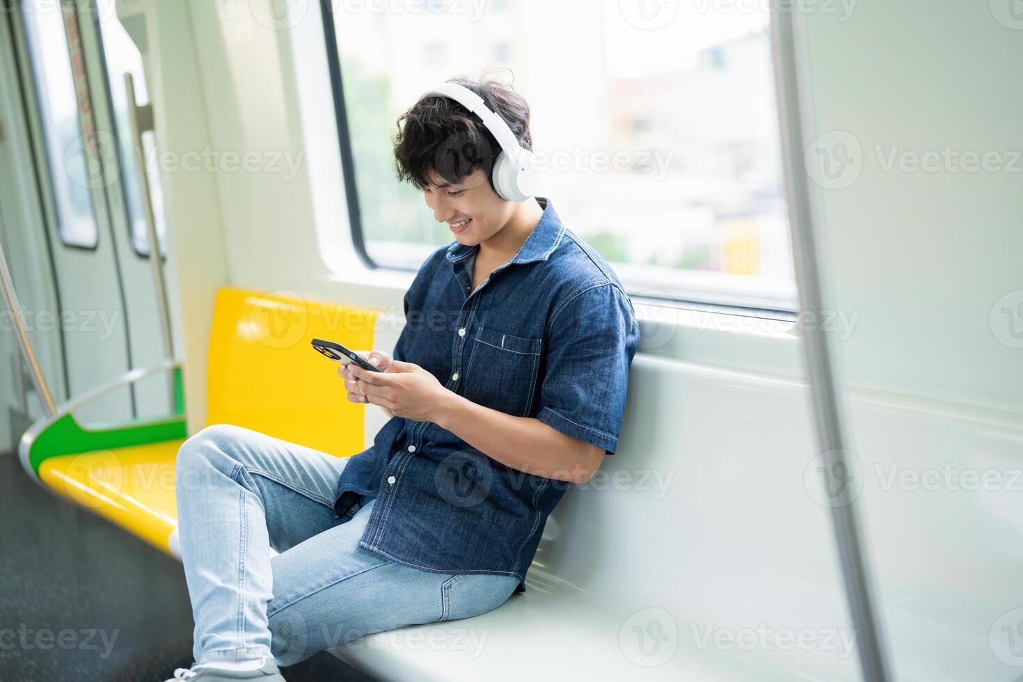 Young Asian man on the metro photo