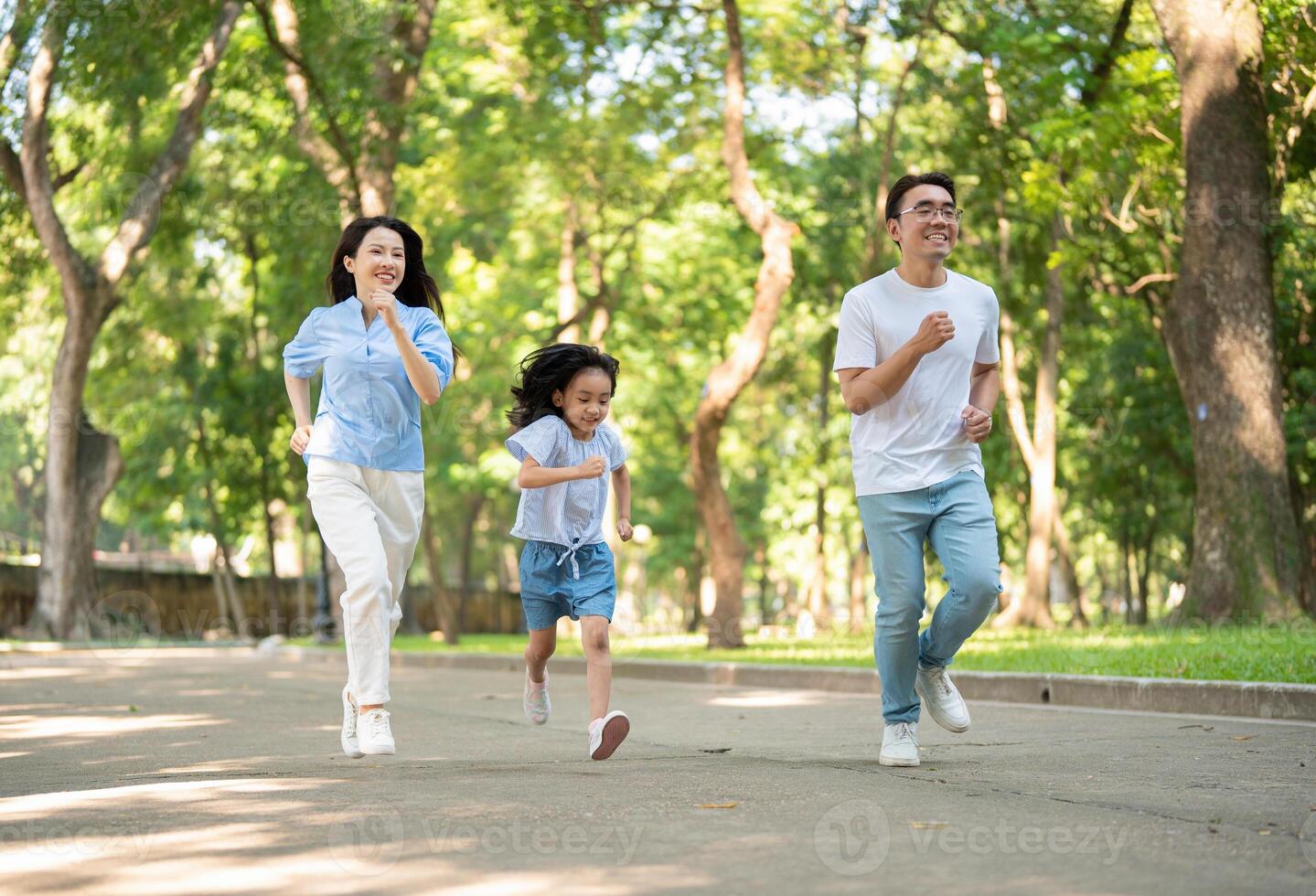 Photo of young Asian family at park