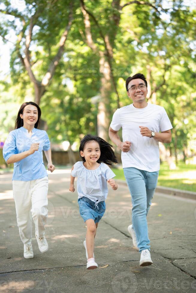 Photo of young Asian family at park