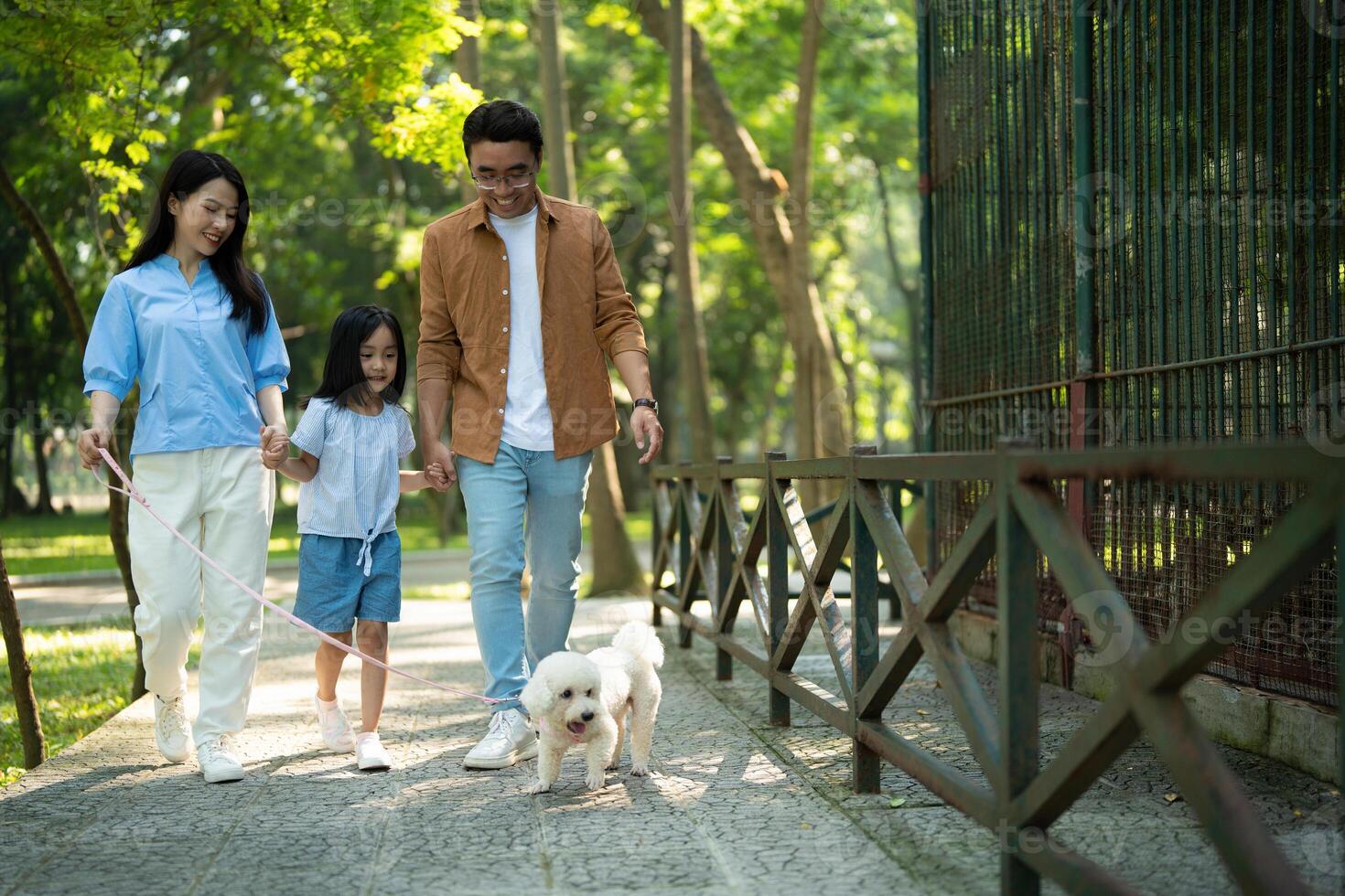 Photo of young Asian family at park