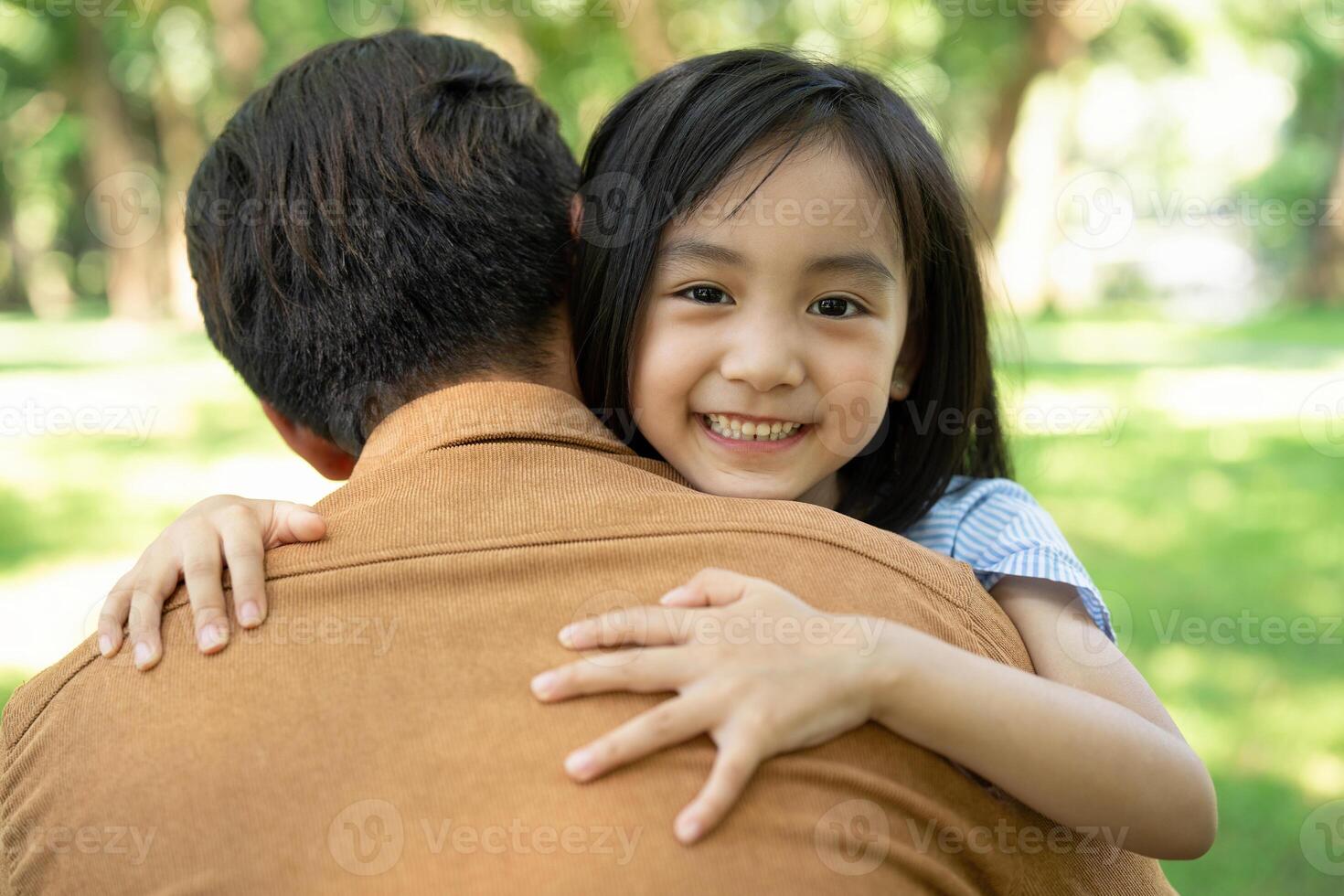 Photo of Asian father and daughter at park