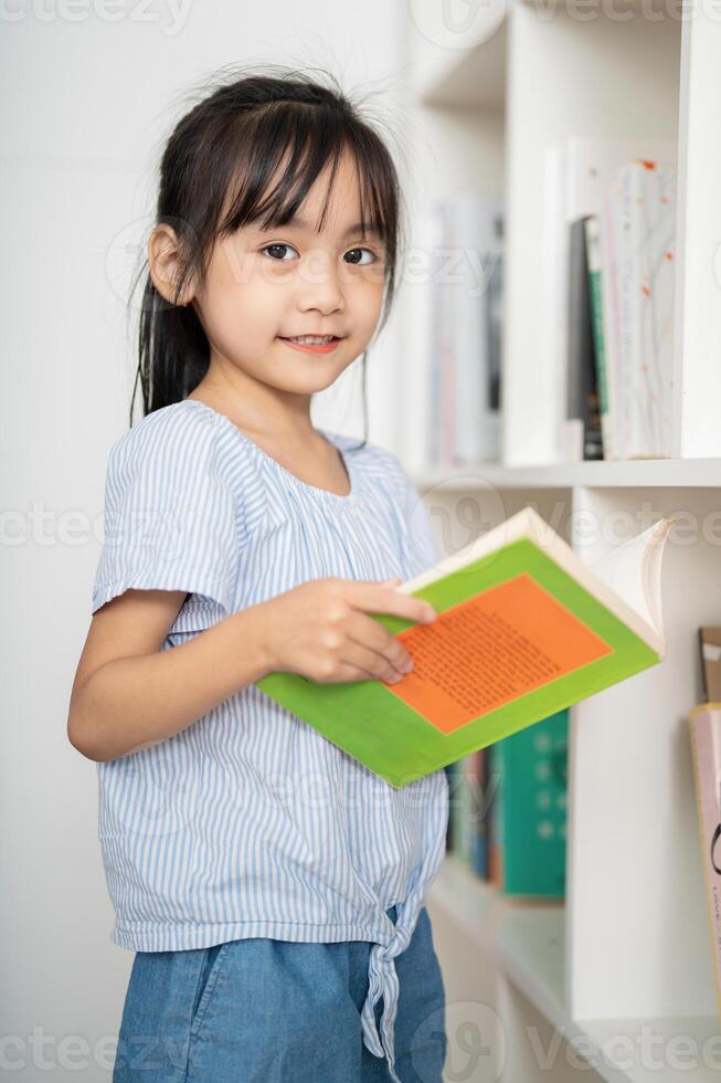 Photo of young Asian baby girl studying at home