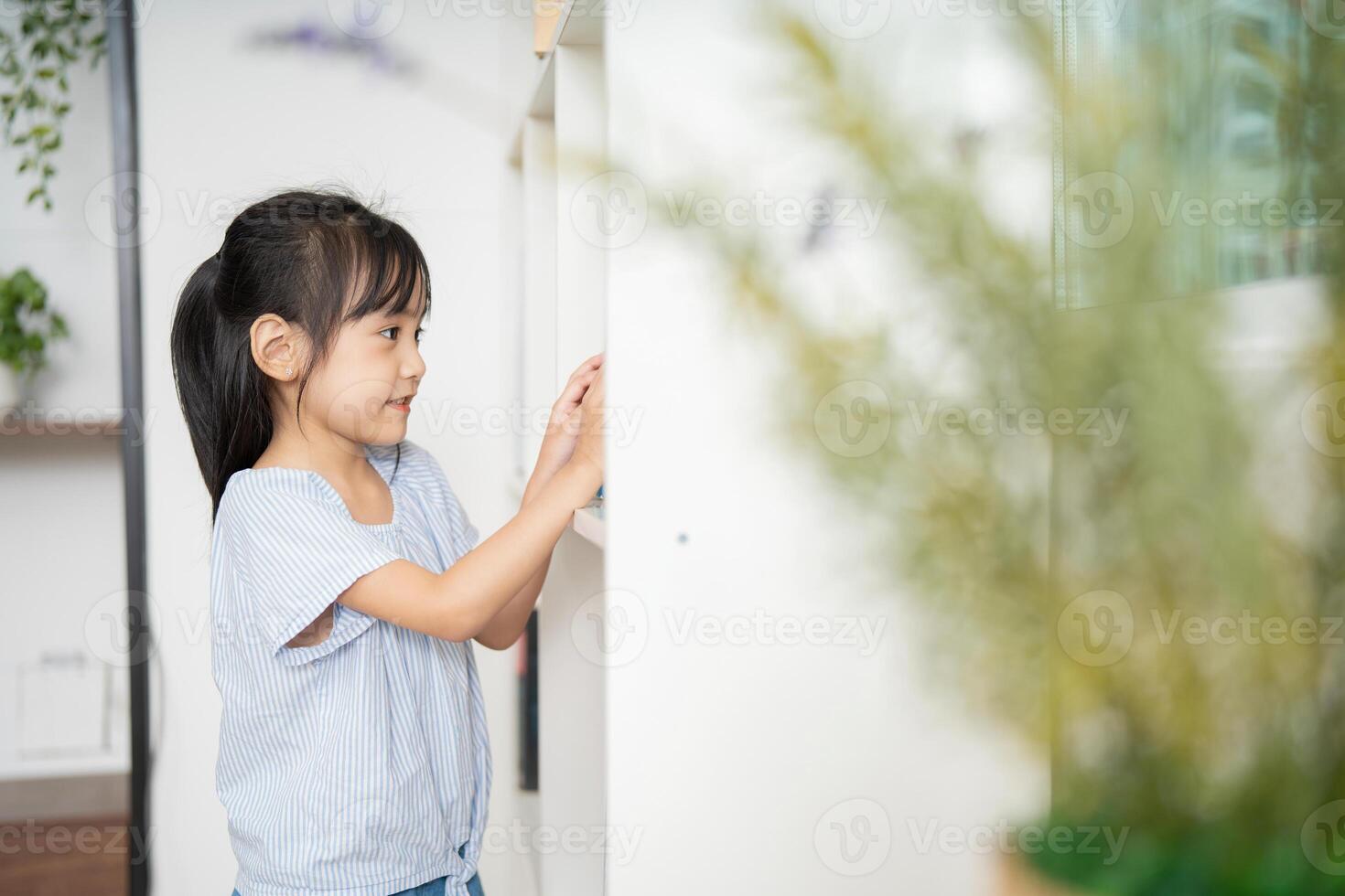 Photo of young Asian baby girl studying at home