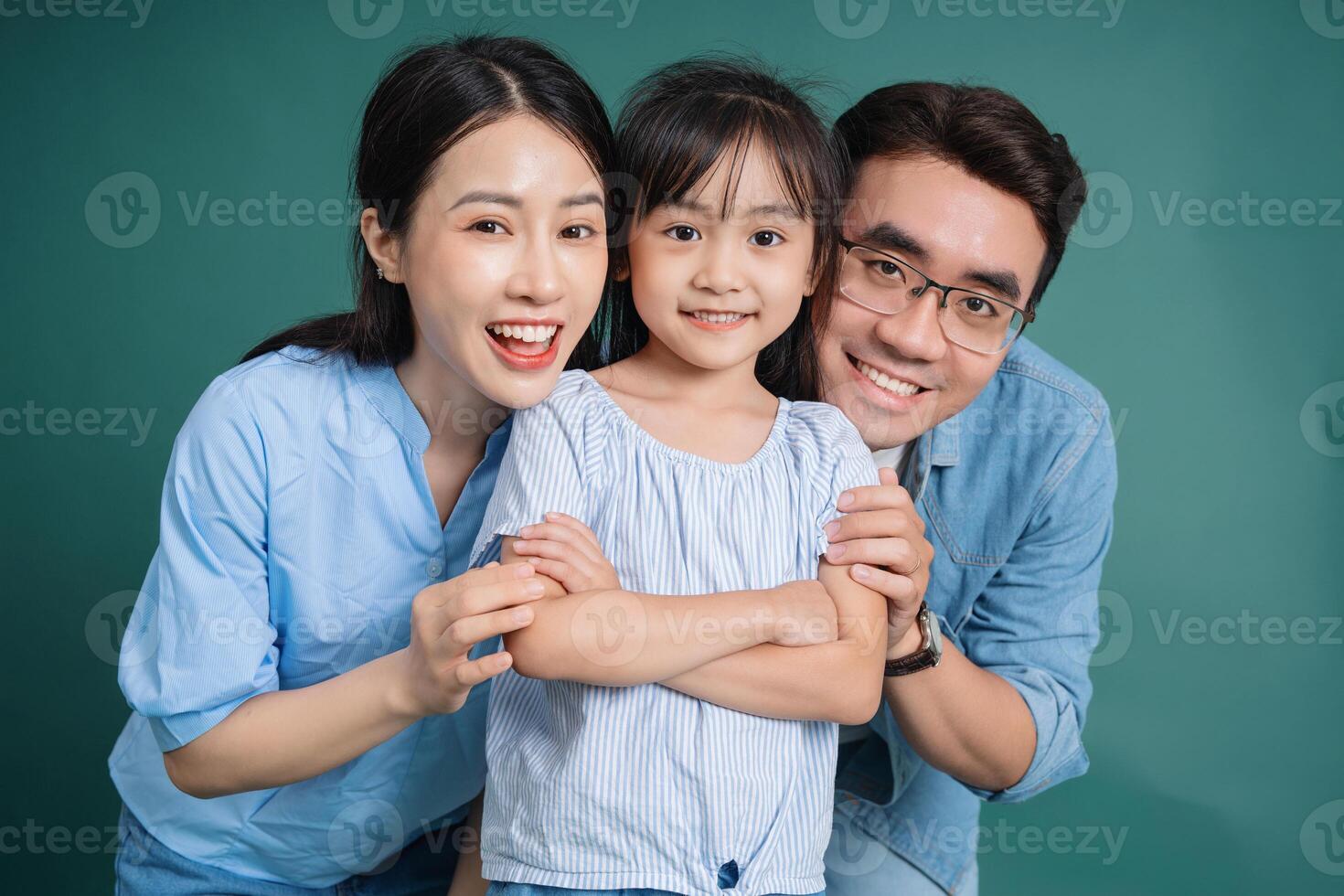 Photo of young Asian family on background