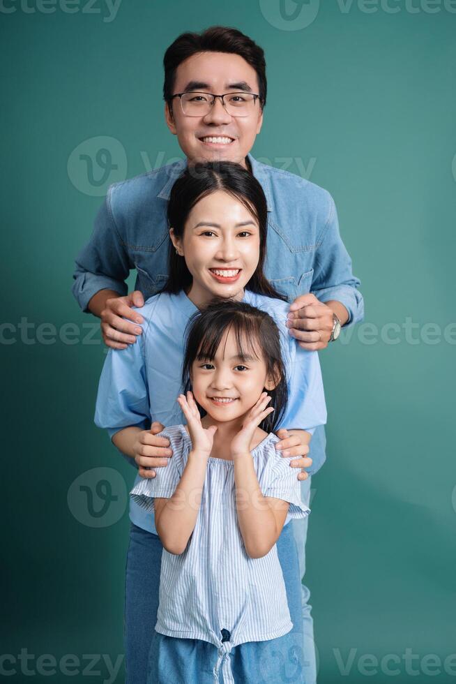 Photo of young Asian family on background