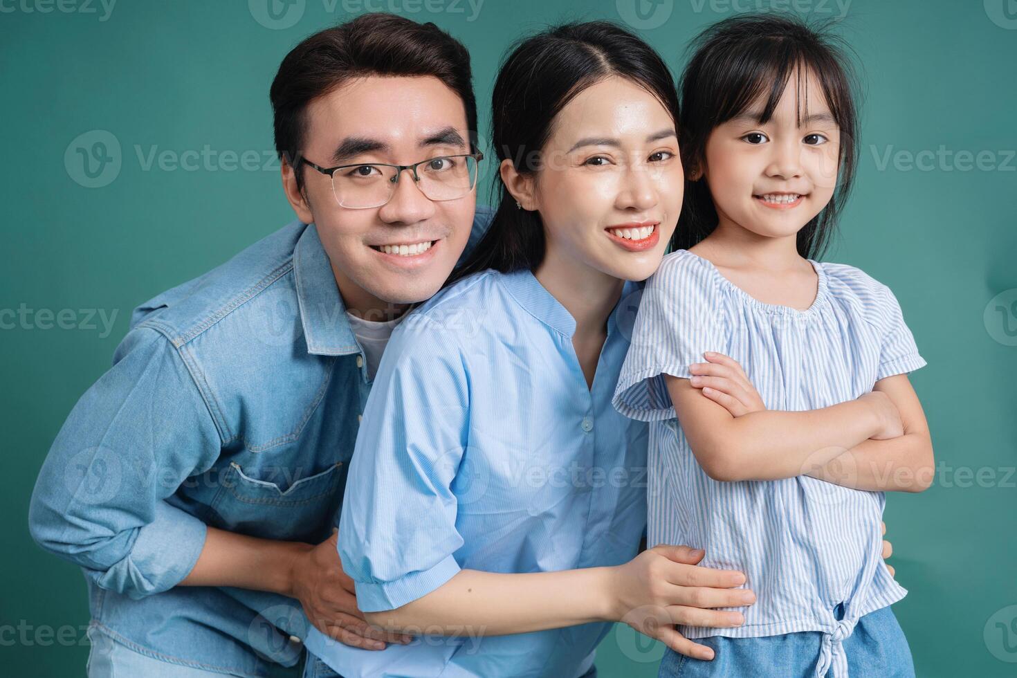 Photo of young Asian family on background