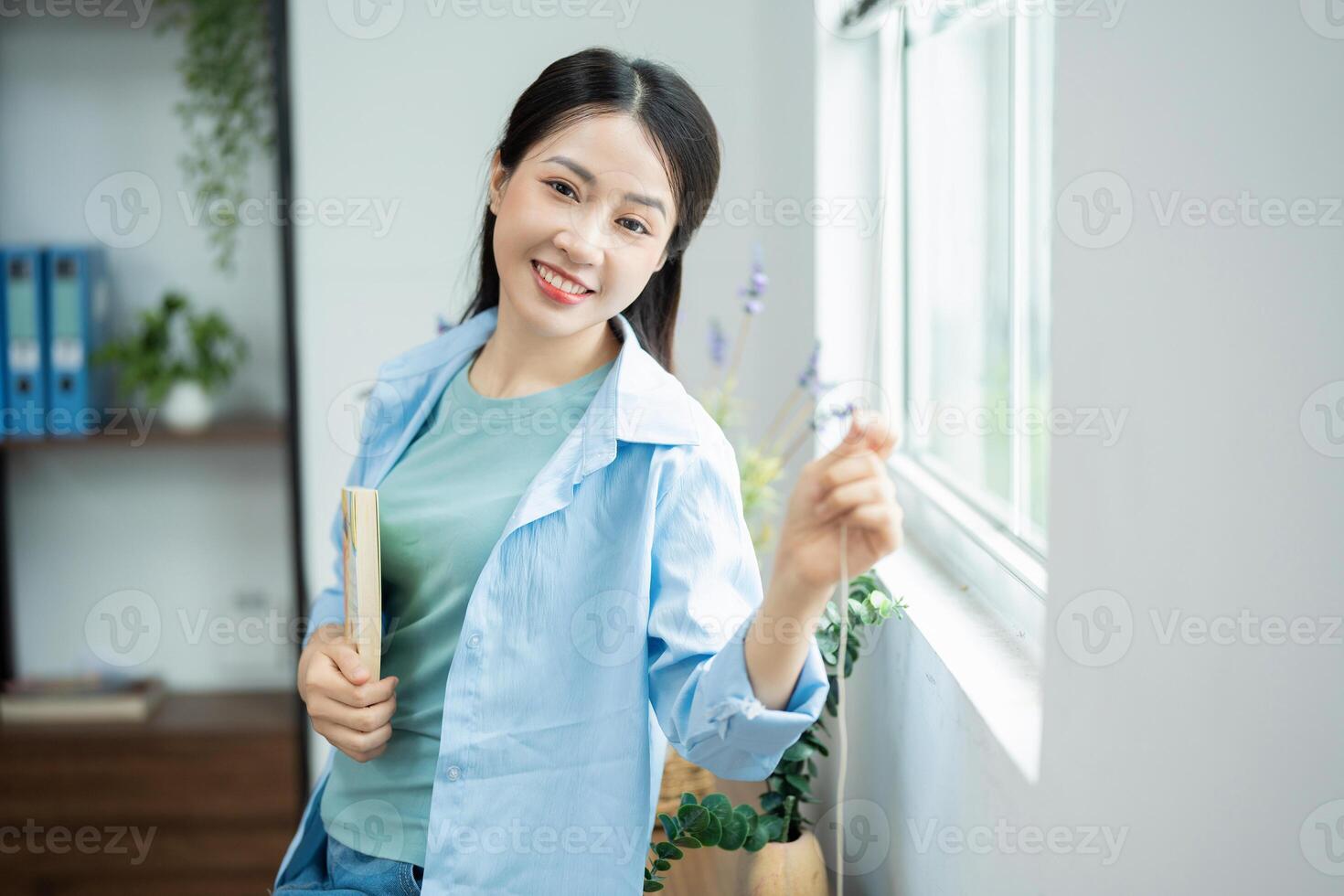 Photo of young Asian woman at home