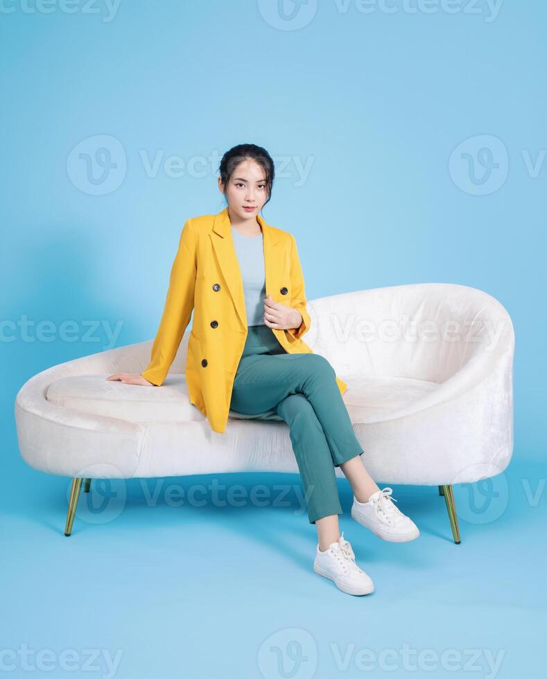 Photo of young Asian businesswoman on background