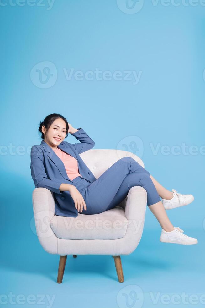 Photo of young Asian businesswoman on background