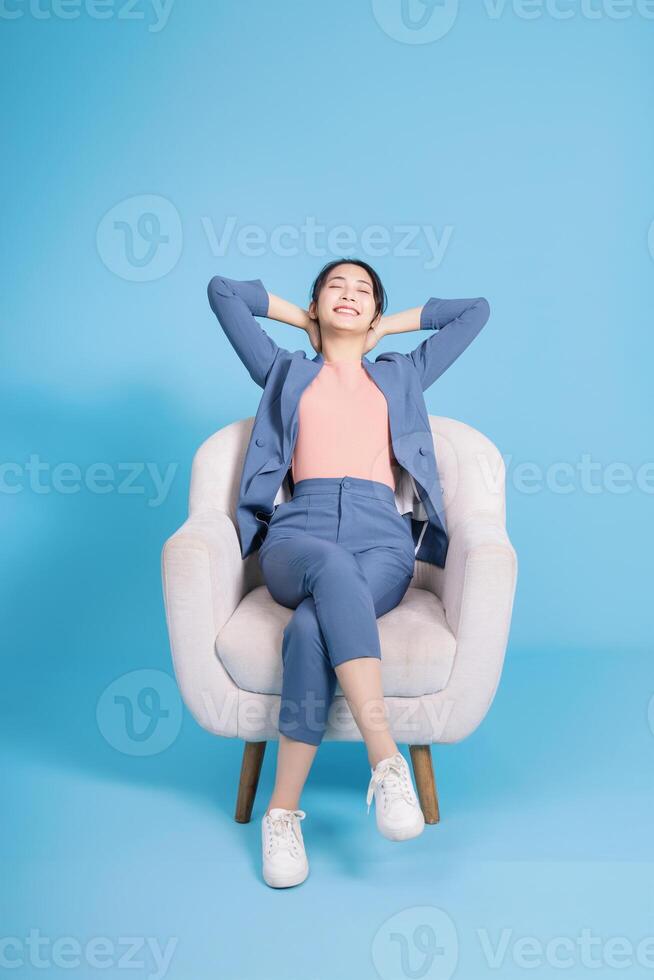 Photo of young Asian businesswoman on background